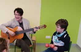 Musikunterricht an der Marienschule in Bad Hönningen. Die Rektorin singt mit den Kindern und begleitet dabei mit der Gitarre.